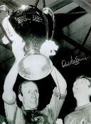 Football. Alex Stepney Hand signed 16x12 black and white photo. Photo shows Stepney holding aloft