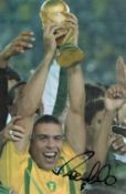 Ronaldo signed 12x8 inch colour photo pictured lifting the World Cup while playing for Brazil.