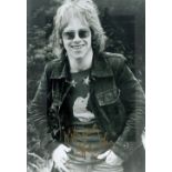 Elton John signed 12x8 inch black and white vintage photo. Good condition. All autographs come