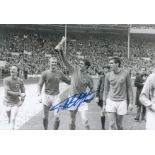 Autographed GEOFF HURST 12 x 8 photo - B/W, depicting the England striker holding aloft the World