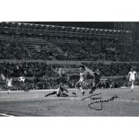 Autographed TERRY McDERMOTT 12 x 8 photo - B/W, depicting the Liverpool midfielder slotting the ball