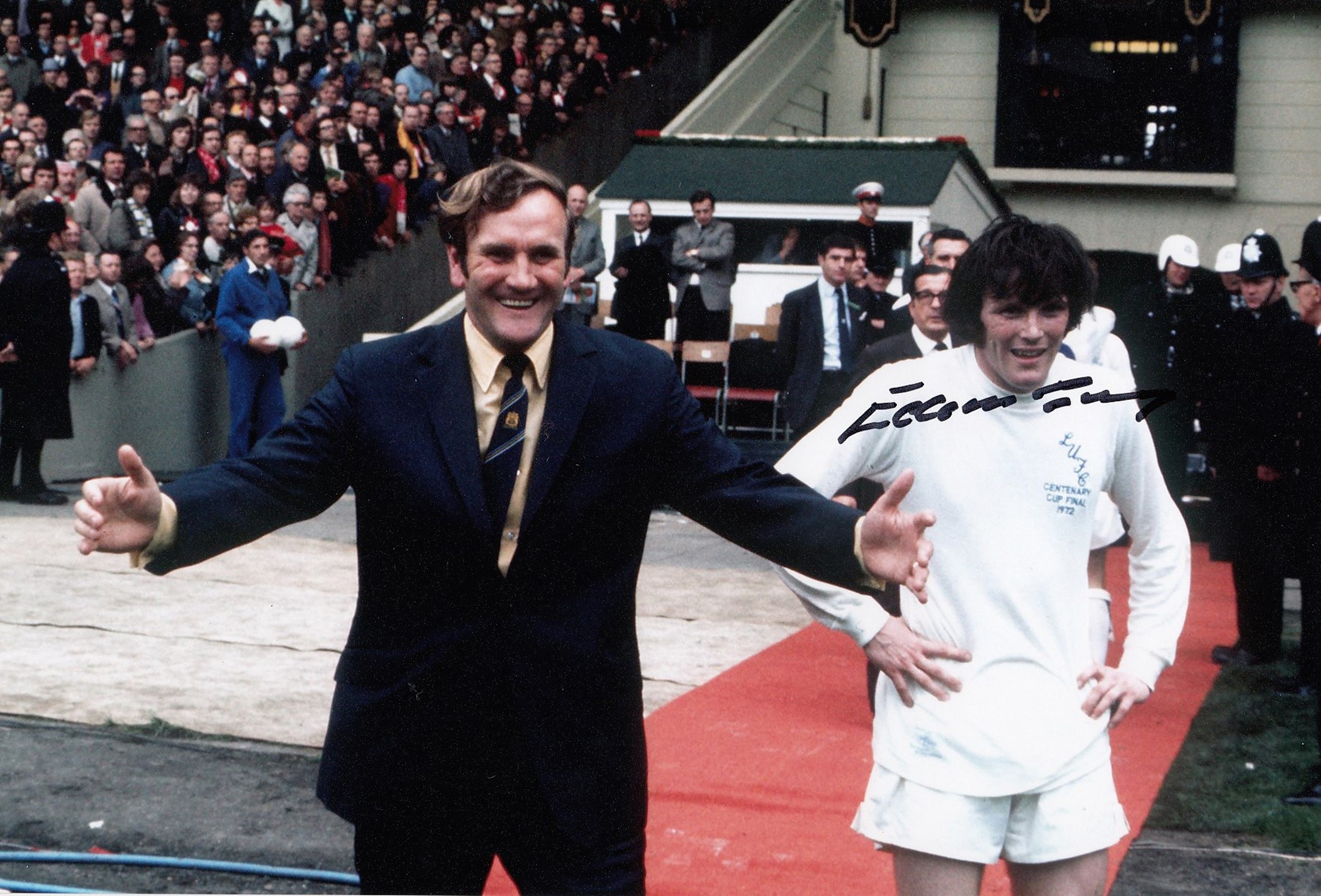 Autographed EDDIE GRAY 12 x 8 photo - Col, depicting Gray and manager Don Revie celebrating Leeds