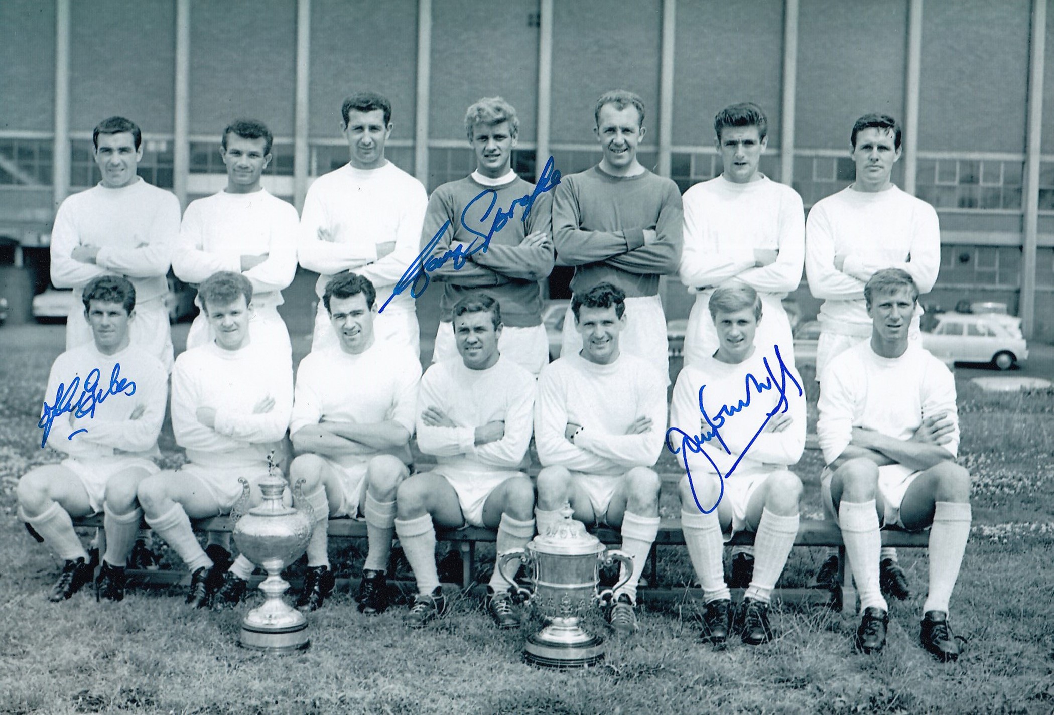 Autographed LEEDS UNITED 12 x 8 photo - B/W, depicting the 1964 Second Division winners posing