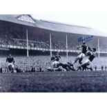 Autographed ROGER HUNT 16 x 12 photo - B/W, depicting a superb image showing the Liverpool striker