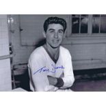 Autographed TONY DUNNE 16 x 12 photo - B/W, depicting a wonderful image showing the Manchester