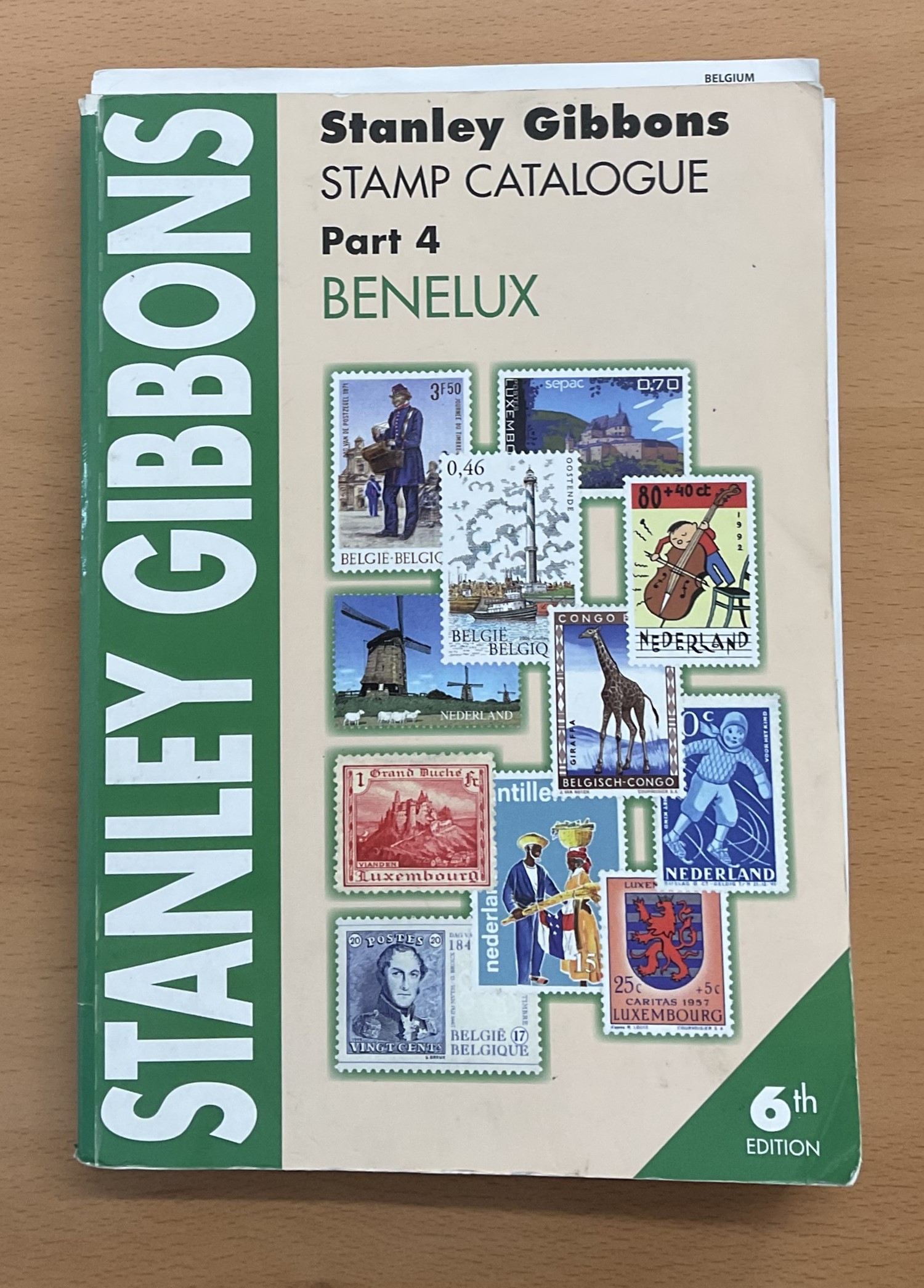 Stanley Gibbons Benelux stamp catalogue 6th Edition. Has damage to inside some pages are becoming