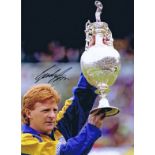 Autographed GORDON STRACHAN 16 x 12 photo - Col, depicting the Leeds United captain holding aloft