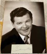 Comedian Benny Hill small signed piece with 10 x 8 b/w unsigned photo. Good Condition. All