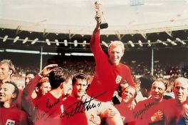 Geoff Hurst, Martin Peters and George Cohen signed 18x12 1966 World Cup Final photo. Good Condition.