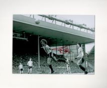 Jimmy Nicholl signed 14x12 overall mounted black and white photo pictured in action for Manchester