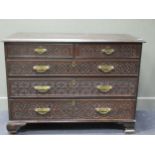 A 19th century oak chest of drawers with blind frett carved decoration, comprising of two short over