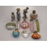 A collection of 11 glass and ceramic scent bottles, and a small Coninental figure (restored) (12)