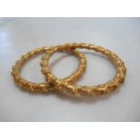 Two Asain wax filled childrens bangles, inside diameter 5.2cm, tested as 22ct gold, gross weight