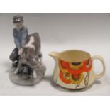 A Royal Copenhagen boy with a cow together with a Clarice Cliff Rodanthe pattern milk jug (2)