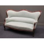 A 19th Century French Show wood frame settee of serpentine outline upholstered in green patterend