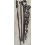 A collection of carved african canes and walking sticks