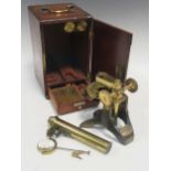 A brass microscope by Arnold & Sons in a mahogany case