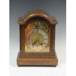 An early 20th oak mantle clock, with arched form