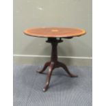 A 19th Century mahogany tilt top wine table, diameter 74 cm