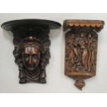 An Indian style carved hardwood figural wall bracket and an oak female mask wall bracket (2)