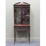 An Edwardian mahogany display cabinet on stand with blind frett carved decoration, 192 x 77 x 44cm