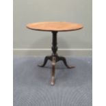 A 19th Century mahogany circular tilt up top table on turned coloumn and tripod base, 72 x 76 cm