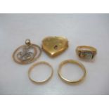 A heart shaped locket tested as 18ct gold, a signet ring tested as 18ct gold, a wedding ring