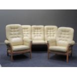 An Ercol three piece suite comprising of a three seater sofa and a pair of arm chairs, together with