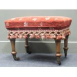 Stamped "BULSTRODE CAMBRIDGE" a walnut stool on turned and tapering legs with ceramic castors, 45