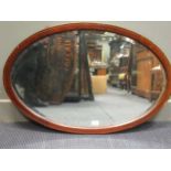 An Edwardian mahogany oval wall mirror with bevelled plate 89 x 61cm