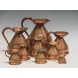 A matched set of nine graduated copper jugs, quart to 1/8th gill, and one smaller (9)