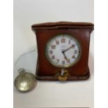 Asprey - a folding travelling bedside clock in a brown leather case together with a pocket watch