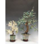 A Chinese cloisonné vase, modern, decorated with storks and containing artificial bonsai with