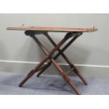 An Arts & Crafts Glasgow school mahogany butlers tray on folding stand stamped "Wylie & Lochead,