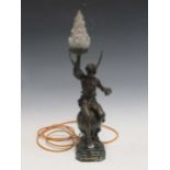 A late 19th/early 20th century spelter figural lamp ‘Le Genie des arts’ with a frosted flambeaux