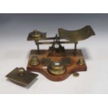 A set of postal scales and weights with rates for letters and parcels engraved