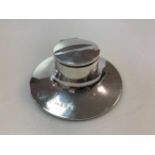 A silver capstan desk inkwell with glass reservoir, 95mm diameter.