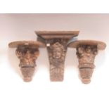Three antique wooden brackets and two other carved oak furniture mounts depicting the moon (5)