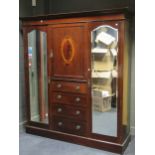 An Edwardian mahogany combination wardrobe, with central marquetry panel above four drawers, flanked