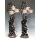 A pair of modern spelter three light lamps depicting classical maiden holding two birds, with floral