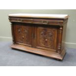 A Continental carved oak sideboard with later marble top, comprising of two frieze drawers over