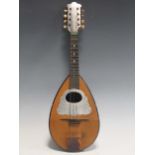 A traditional mandolin, a column stand and a shaped square tray