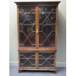 A 19th Century mahogany bookcase enclosed by two pairs of glazed doors on bracket feet, 201 x 121