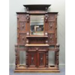 A Victorian carved oak hallstand with mirror back and later marble inset top decorated with lion