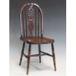 An oak child's chair with pierced wheel splat, 62 cm high