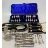 A collection of silver flatware including a cased set of 6 teaspoons, a cased set of 11 teaspoons