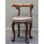 An early Victorian oak chair, the curved back rest over scroll supports to a circular seat on scroll