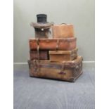 A vintage leather trunk/case and four smaller cases plus a top hat in box