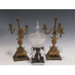 A pair of gilt metal candelabra and a moulded glass sweatmeat dish and cover on a metal base hung
