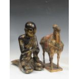 An oriental carved wood and gilt figure of a kneeling Lohan; a carved gilt wood figure of a T’ang
